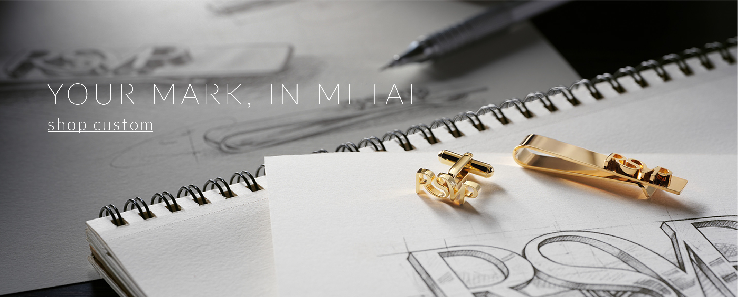 Shop Custom Accessories. Custom cufflinks and tie bar on a drafter's desk.
