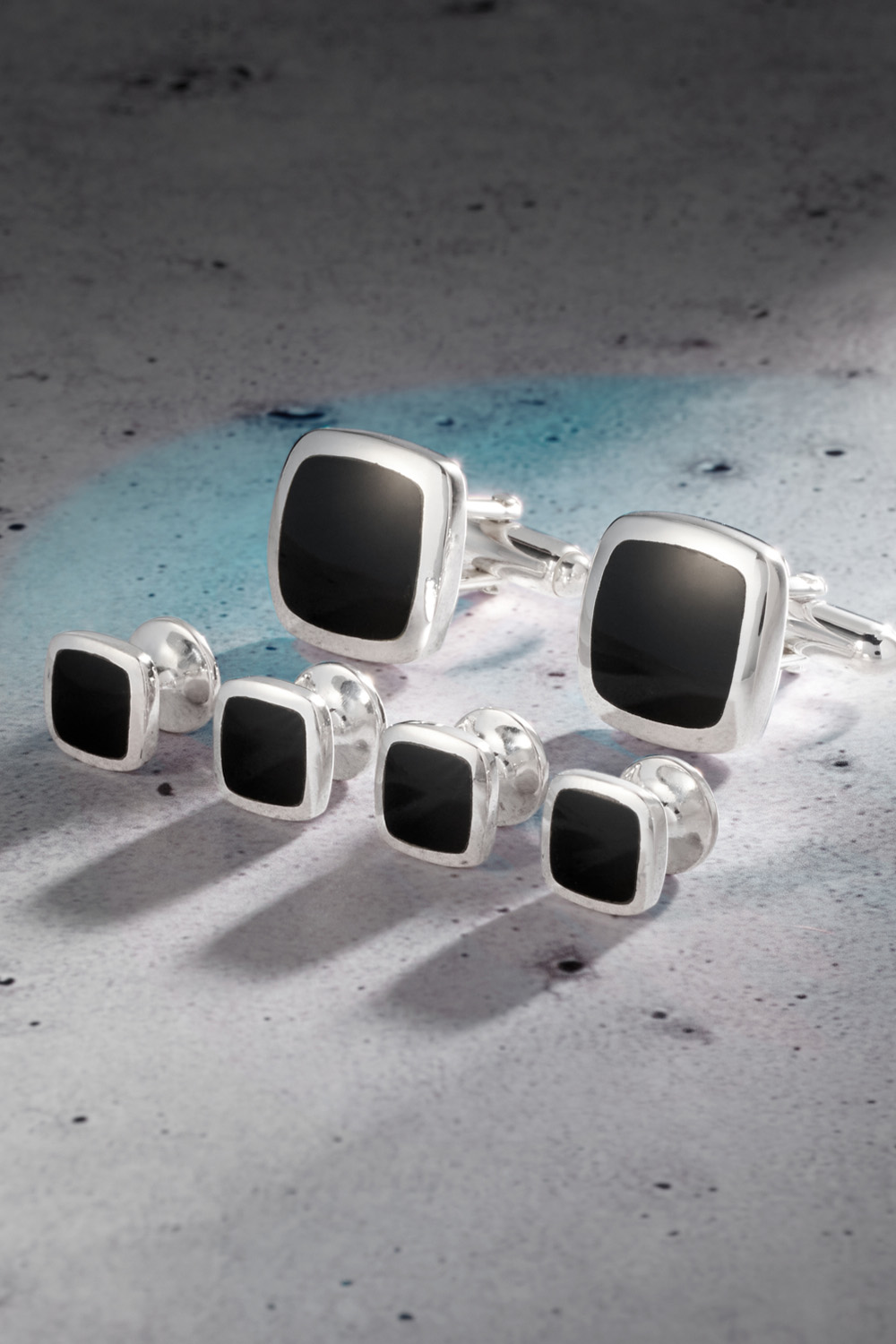 Black and Silver Square Stud Set on a marble table.