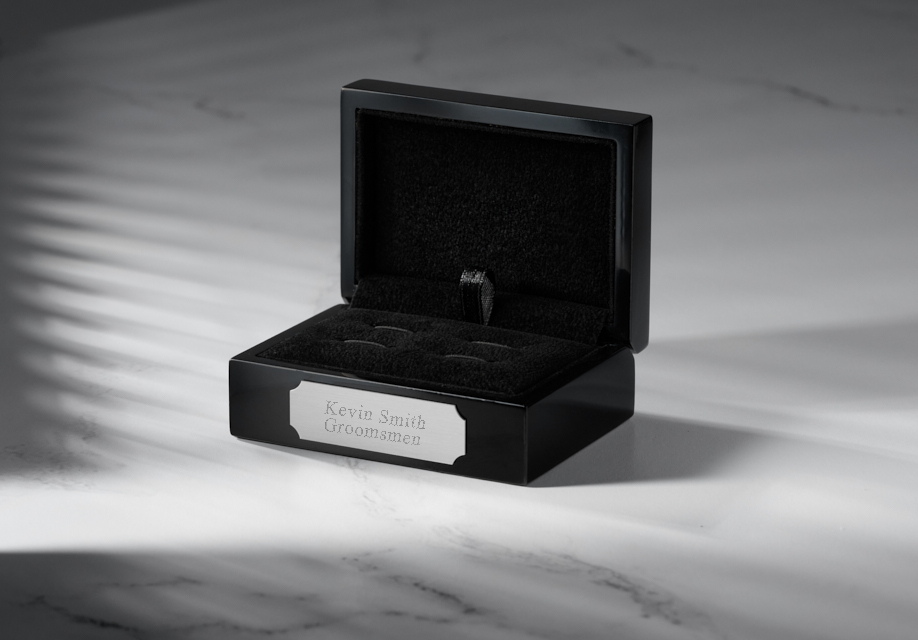 Black lacquer wood box on a marble background.