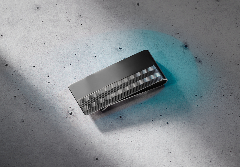Gunmetal money clip on a marble table