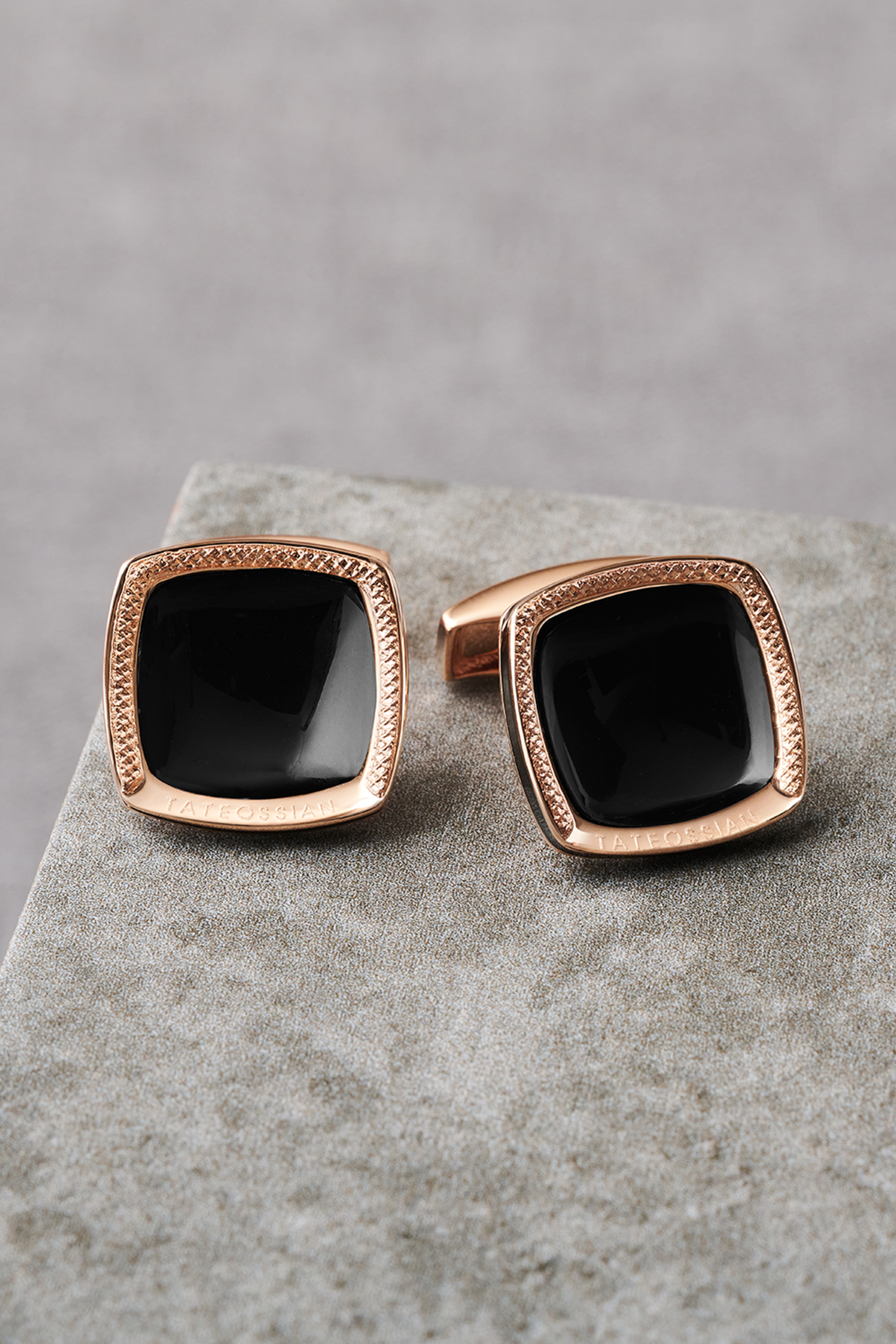 Blue sodalite and silver cufflinks on a tan table.