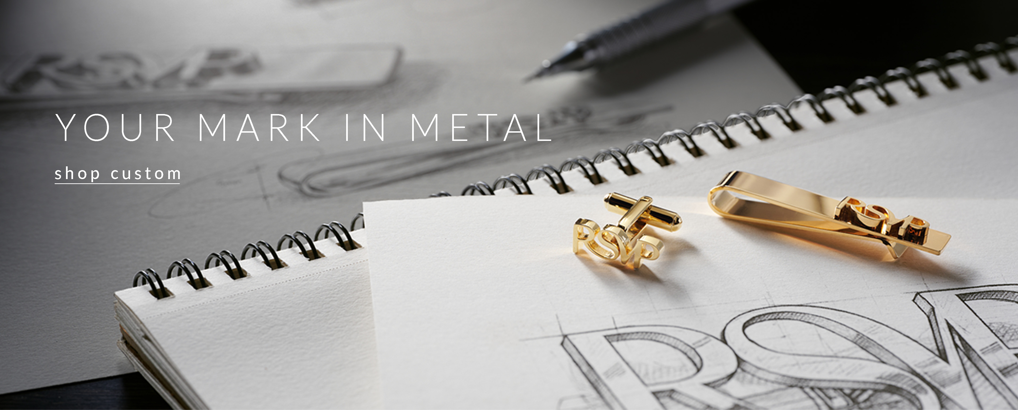 Shop Custom Accessories. Custom cufflinks and tie bar on a drafter's desk.