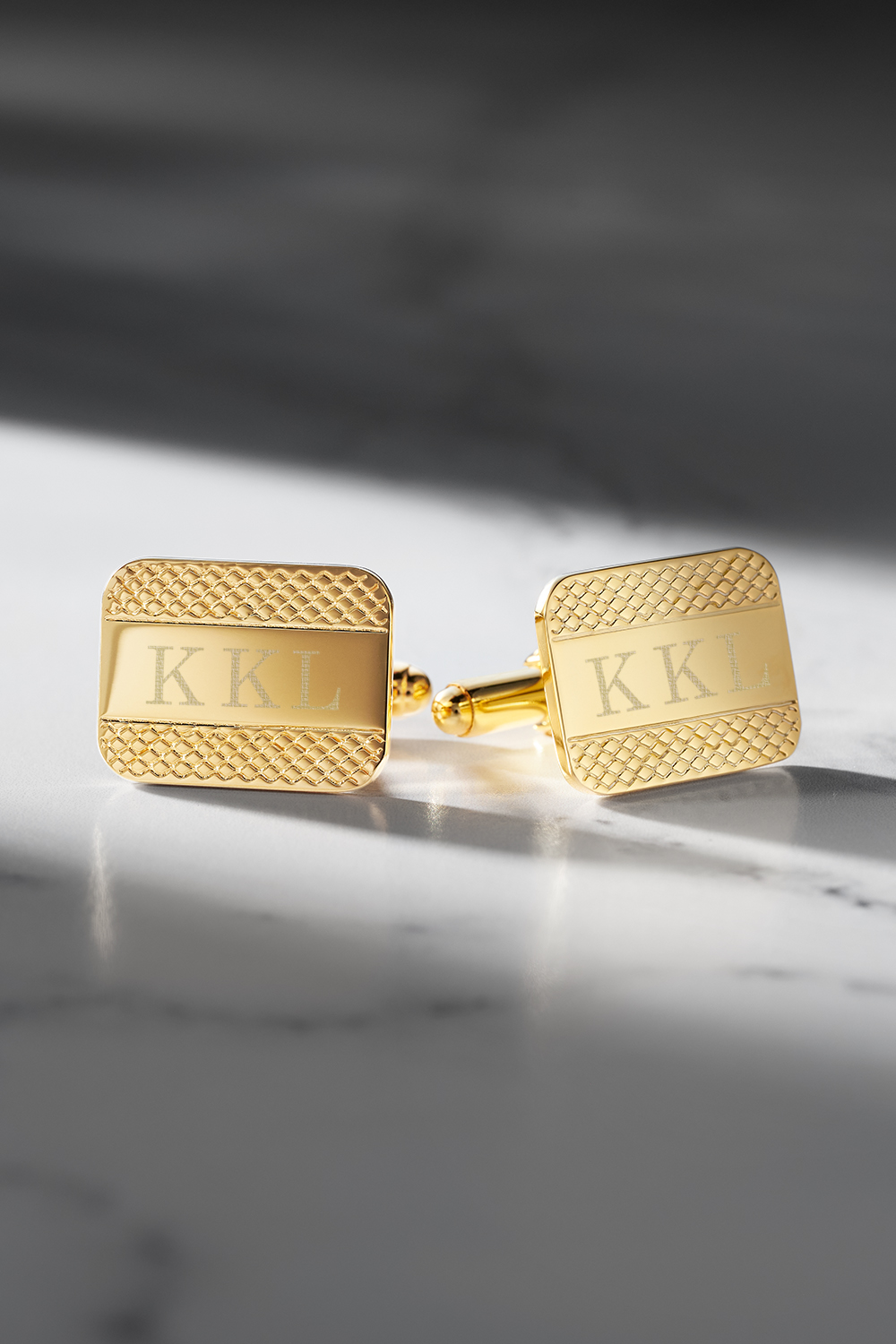 Gold Cufflinks on a marble surface