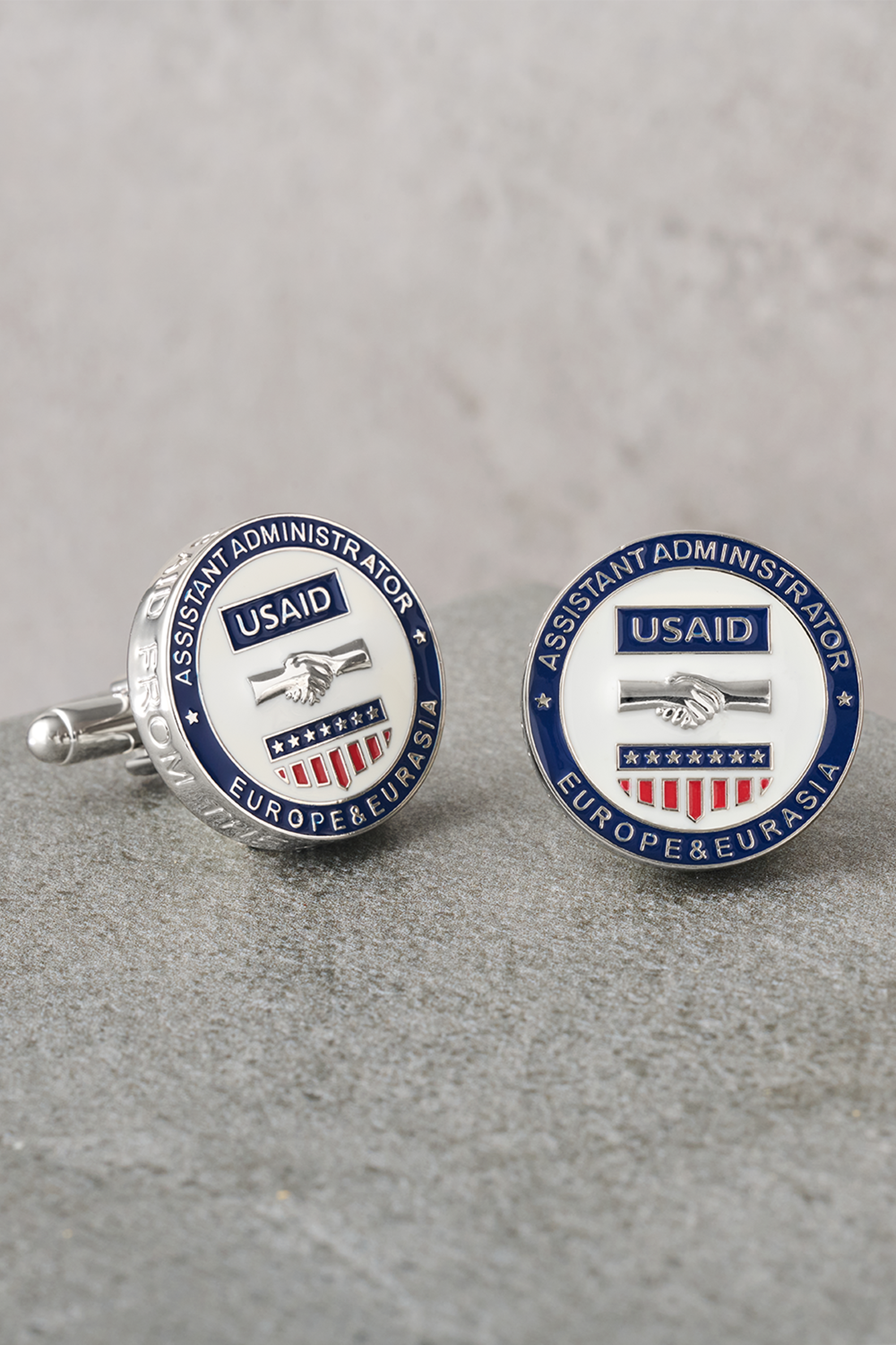 Custom cufflinks on a gray table