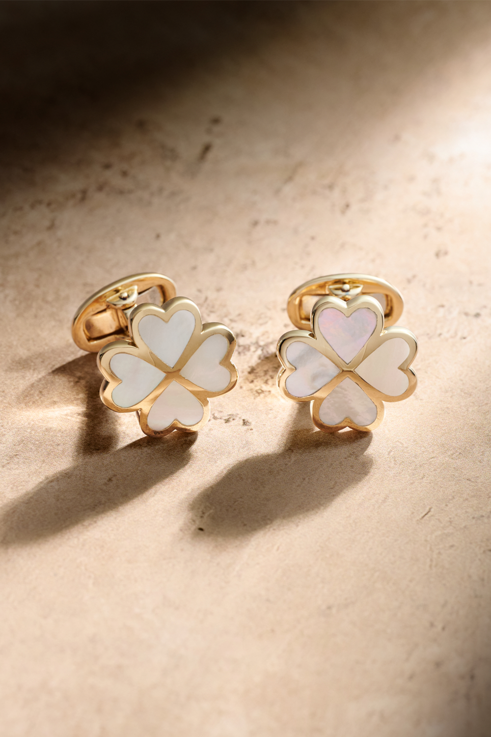 Gold and Mother of Pearl Cufflinks on a tan background